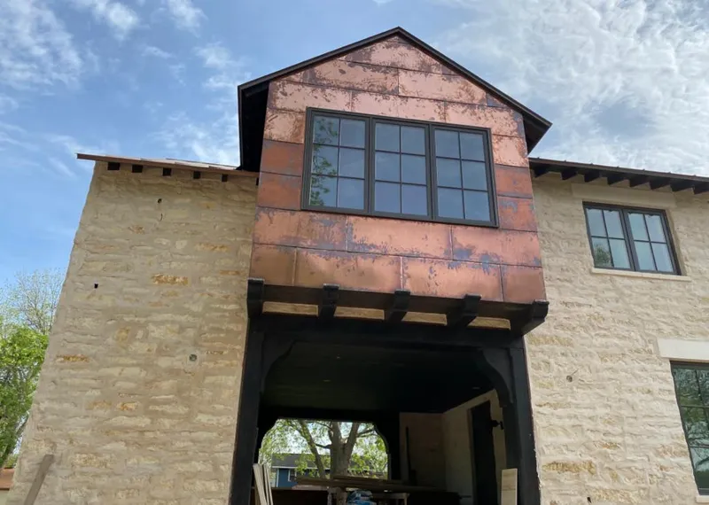 Copper metal panel facade on a stone building for Skylight Installation in Kernersville
